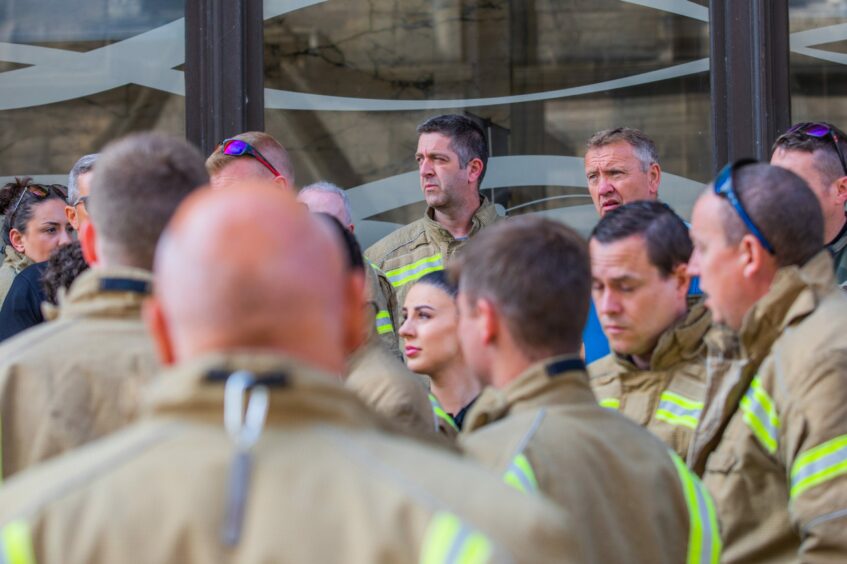 Group of Perth firefighters in uniform at a protest outside Perth and Kinross Council HQ