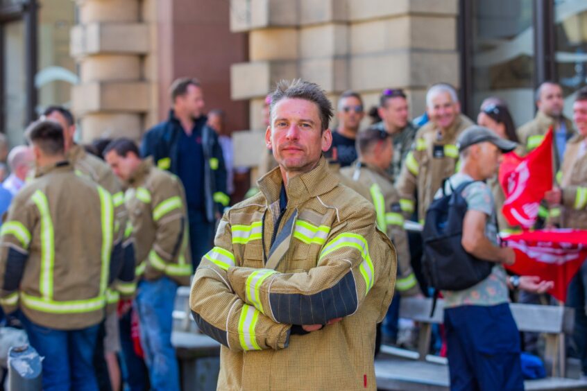 FBU branch secretary David Evans in firefighter uniform at rally outside Perth and Kinross Council HQ.
