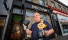 Jock Mcinnes with boxing gloves outside the Bee Bar in Perth.