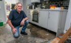 Allan Whyte in flood hit Perth kitchen.