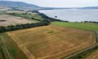 aerial view of Burleigh Golf site, currently a stubble field, with Loch Leven in background.