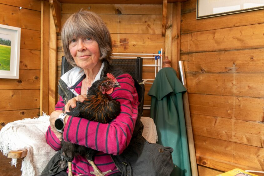 Mary Moore at home in Perth with her surviving chicken called Emerald.