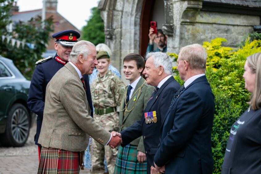 King Charles III shakes hands with Deputy Lieutenant Colonel Andy Middlemiss outside St Paul's Episcopalian Church in Kinross.