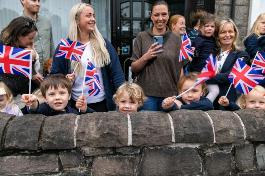 Small children waving Union Jacks on Kinross High Street