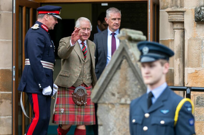 King Charles waving on steps of Kinross Day Centre.