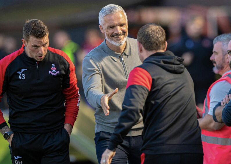 Jim Goodwin shakes hands with Rhys McCabe