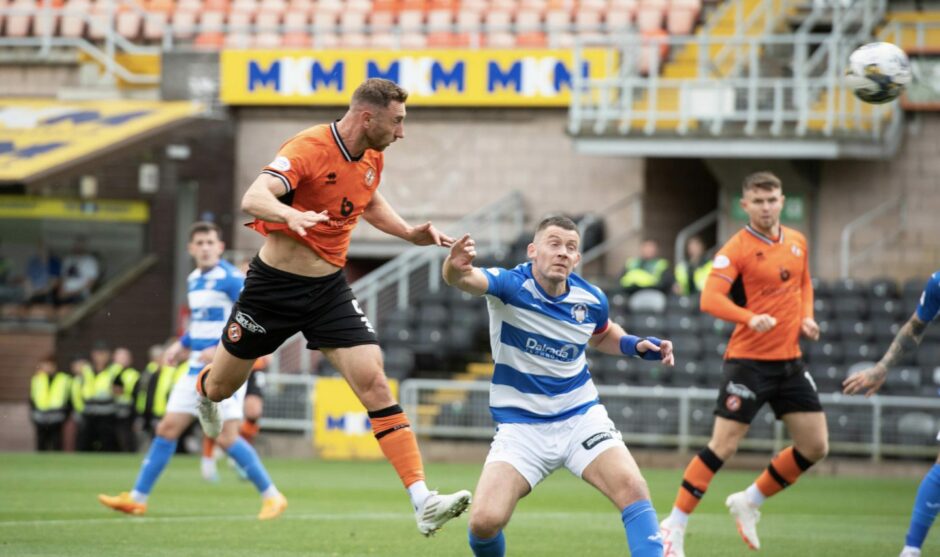 Louis Moult rises highest to score for Dundee United.