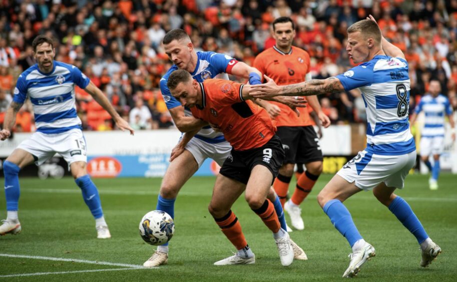 Dundee United striker Louis Moult battles the attentions of Morton defenders