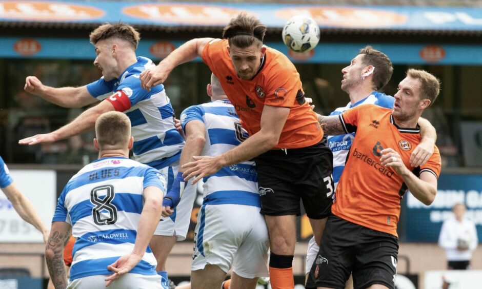 Dundee United man Declan Gallagher challenges for high ball against Morton. 