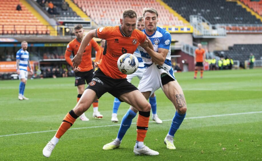 Tyler French tussles with Dundee United marksman Louis Moult.