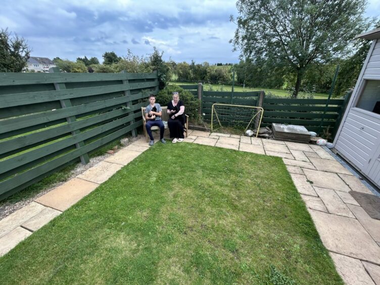 Fiona Raybone-Scott and son, Matthew in the their garden where the cat poo threat was found. 