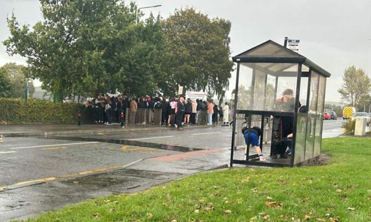 Parents and pupils pay their respects outside Inverkeithing High School after the untimely death of a teenage schoolgirl