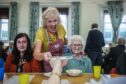 Liz Howson serves up pudding at the latest Brechin Soup Initiative lunch. Image: Mhairi Edwards/DC Thomson