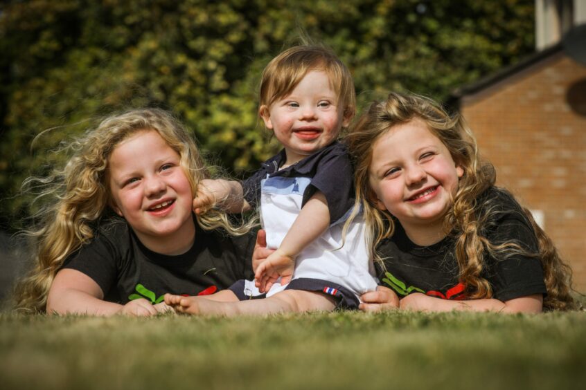 Baby Gregor, who has Down's syndrome, with his two sisters. 