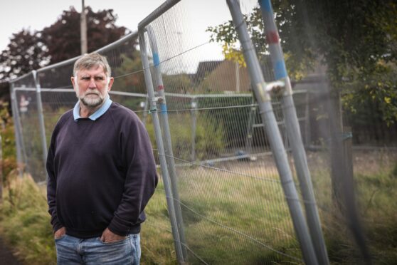 Inveresk Community Council chairman Gus Leighton at the fenced off Inglis Court site.