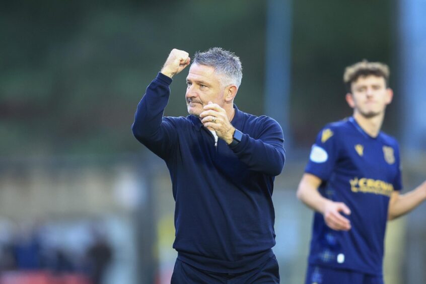 Tony Docherty fist pumps to Dundee fans. Image: David Young/Shutterstock