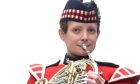 Joanne Lumb in regimental uniform playing French horn