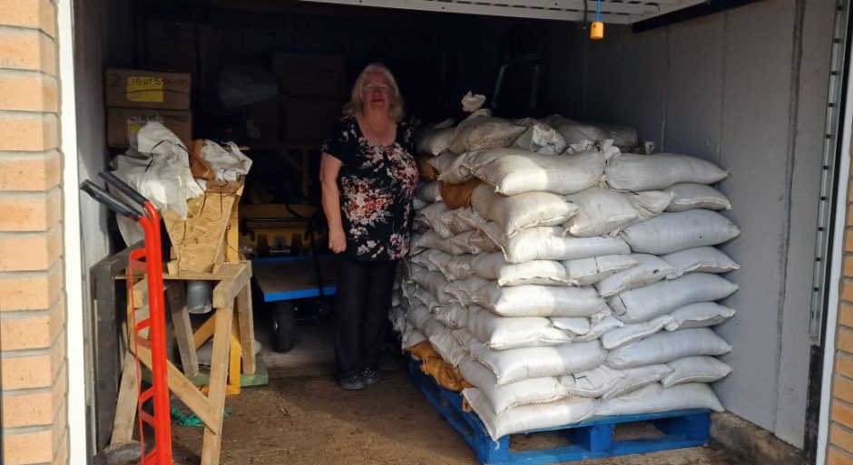 Val Ferguson next to a load of sandbags in the Tayside Waders lock-up in Aberfeldy.