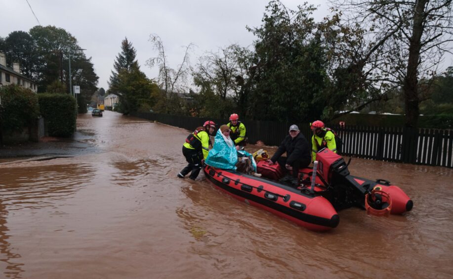 Family are rescued by crews on a dinghy boat in Brechin.