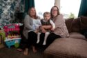 June Soutar (left) is sleeping on her daughter Kerry's sofa after evacuating her flat in Brechin with her granddaughter Ruby. Image: Paul Reid