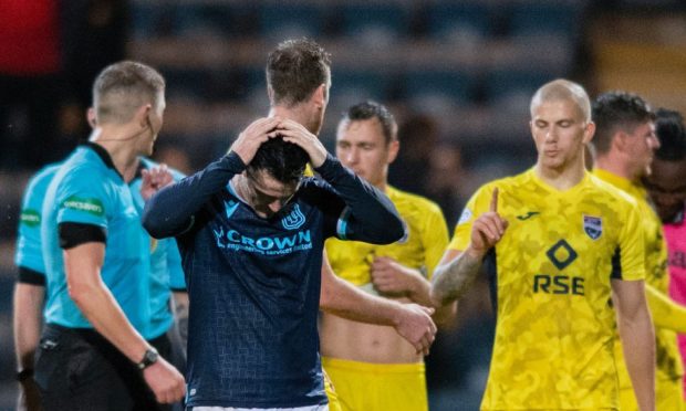 Dundee player is dismayed as Ross County win at Dens Park.