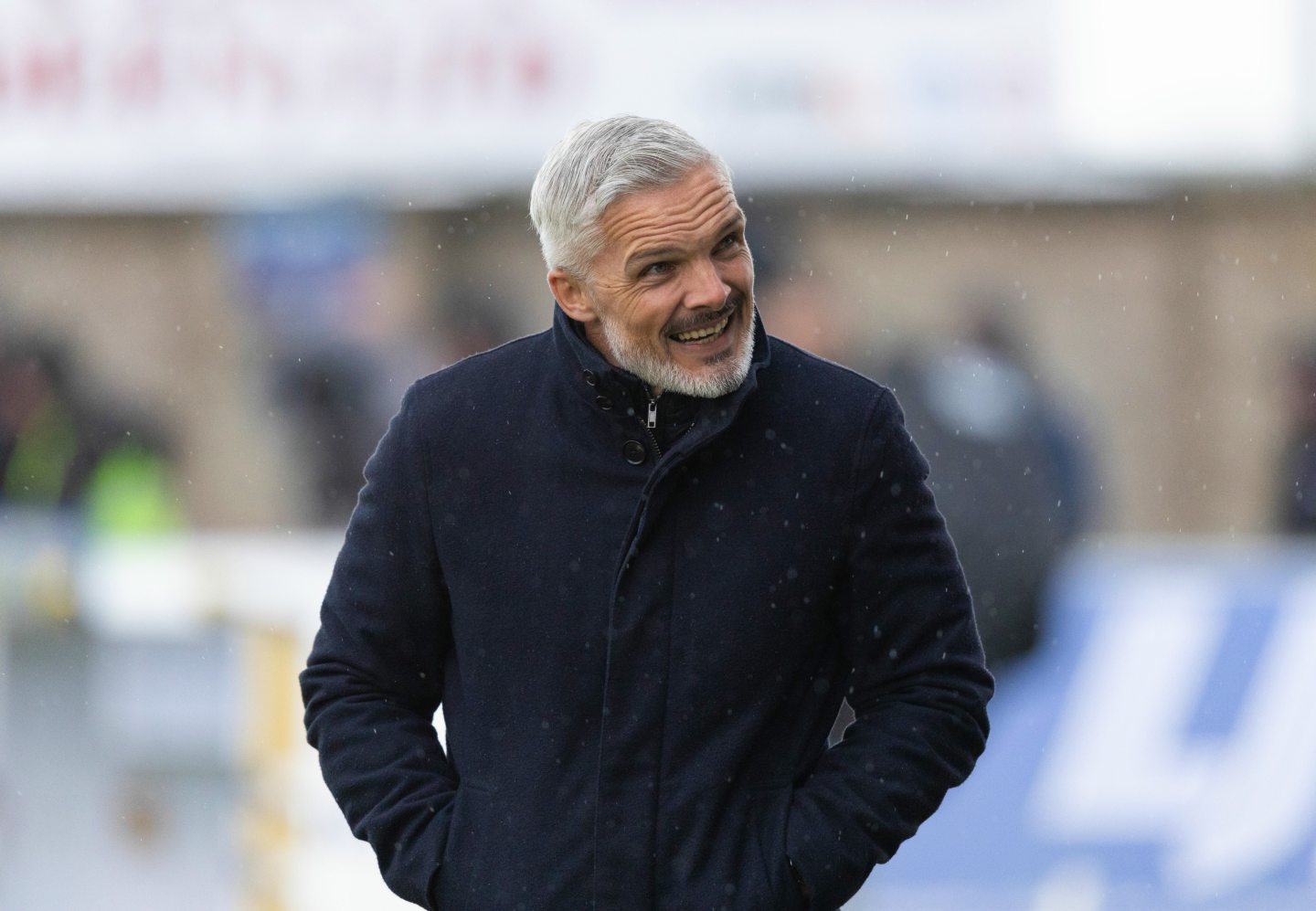 Dundee United boss Jim United boss Jim Goodwin braves the rain in Peterhead