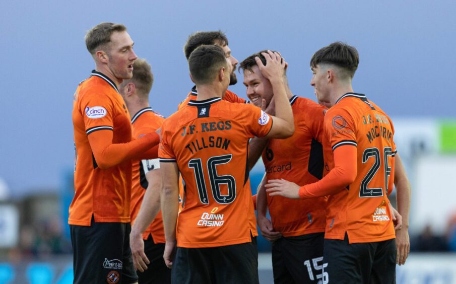 Glenn Middleton is congratulated by his United teammates.