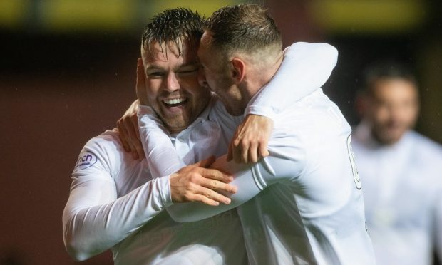 Dundee United duo Glenn Middleton, left, and Louis Moult celebrate in the rain at Tannadice
