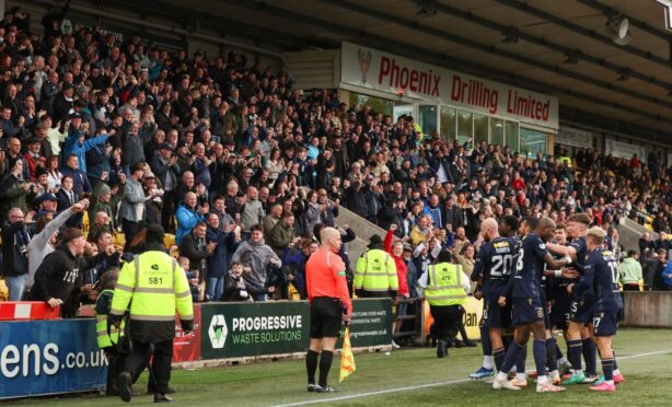 Dundee celebrate in front of the travelling support. Image: SNS