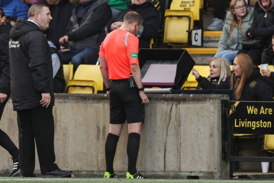 Willie Collum consults his VAR monitor before ruling out Amadou Bakayoko's 'offside' goal against Livingston. Image: SNS