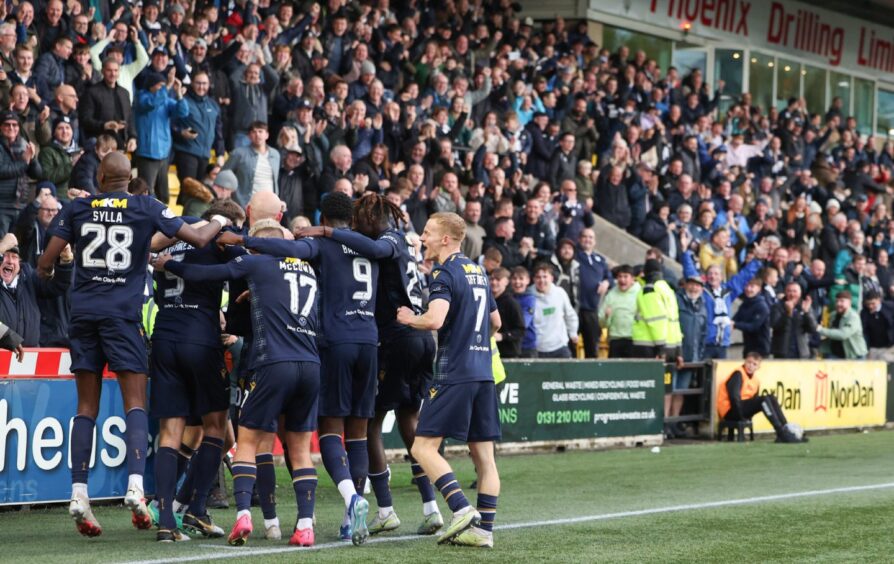 Dundee players celebrate in front of the away support at Livingston. Image: SNS