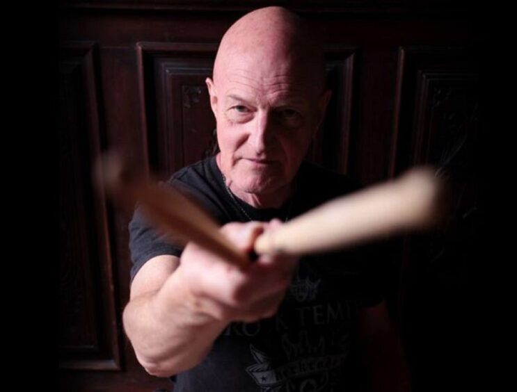 Kinross is set to welcome Chris Slade, pictured pointing his drumsticks at the camera, back for the first time since 2020 next Friday.