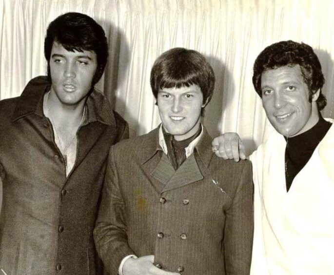 As a teenager Chris Slade, centre, met Elvis Presley, left, while he was in Welsh hit-maker Tom Jones' band.