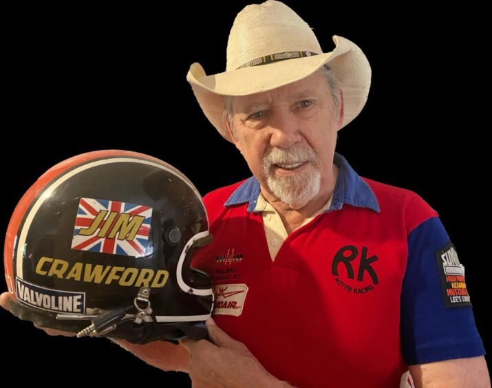 Canadian musician Brian Good, of The Good Brothers, with Jim Crawford's racing helmet, which he still uses for snowmobiling. He is also wearing his original team top from when he was roped into being on Jim's pit crew. Image courtesy of Brian Good.