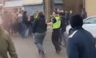 Police try to separate rival fans before the match at Starks Park.