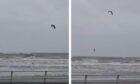 Kite surfer defies Storm Babet warnings to ride waves at Kirkcaldy.