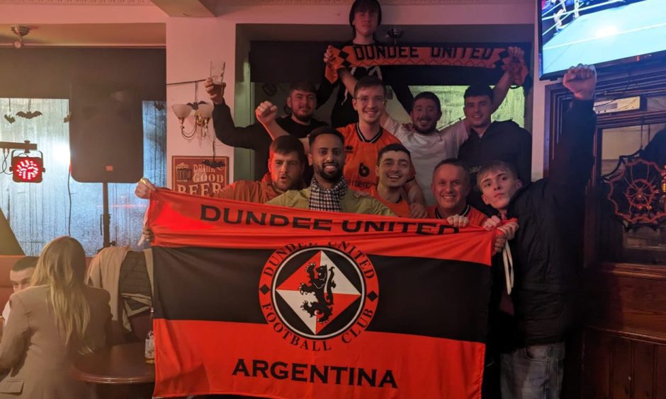 Agustin Mervic (front, third from right) received a heroes welcome at The Snug Bar in Dundee.