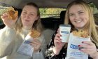 Maria and Joanna holding up their food from Greggs in Dundee