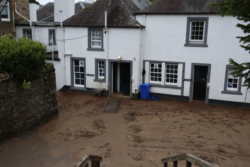 The main house at Dalguise Activity Centre left under several inches of mud. 