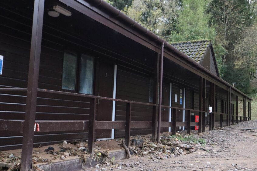 Chalets at Dalguise Activity Centre blocked by several feet of flood debris. 