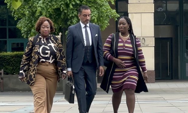 Laywer Aamer Anwar with members of Sheku Bayoh's family arriving at Capital House in Edinburgh for the public inquiry into his death.