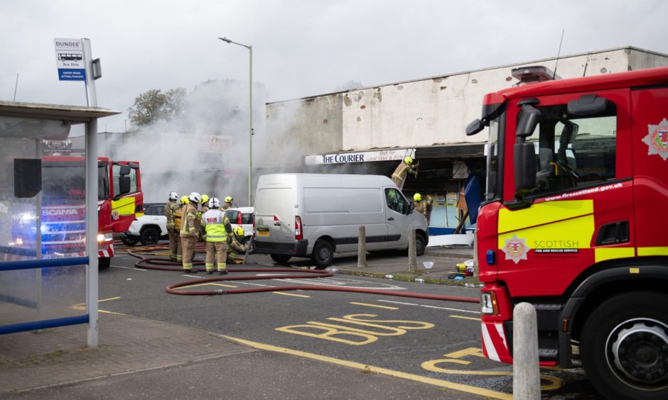Firefighters tackling the blaze at the Best-one shop in Fintry.