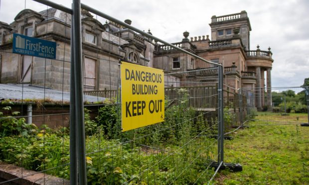 a fence around the dilapidated site of the former Letham Grange resort in Angus