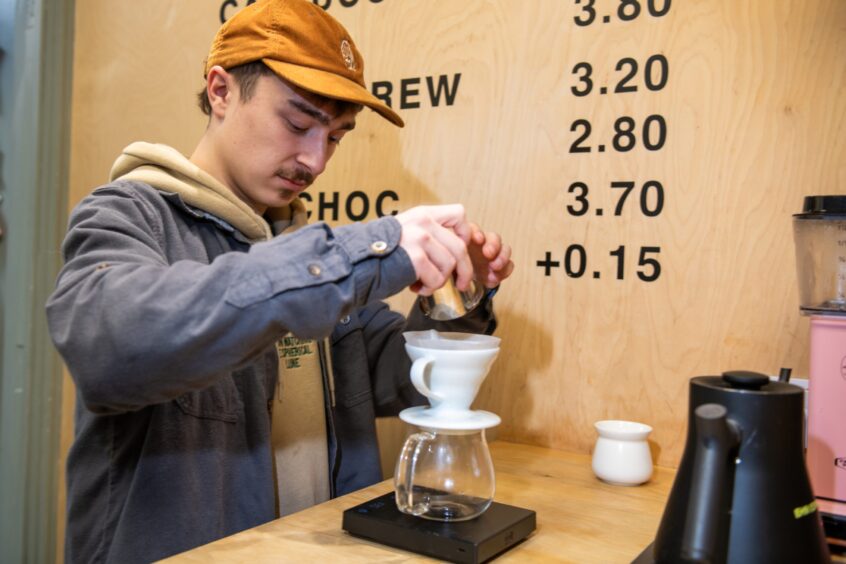 Barista Lewis preparing a pour over coffee in EH9 Espresso.