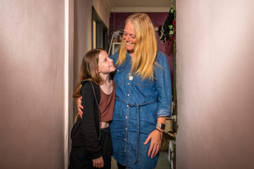 Smiling mum Melanie Stuart hugs ten-year-old daughter Charlotte.