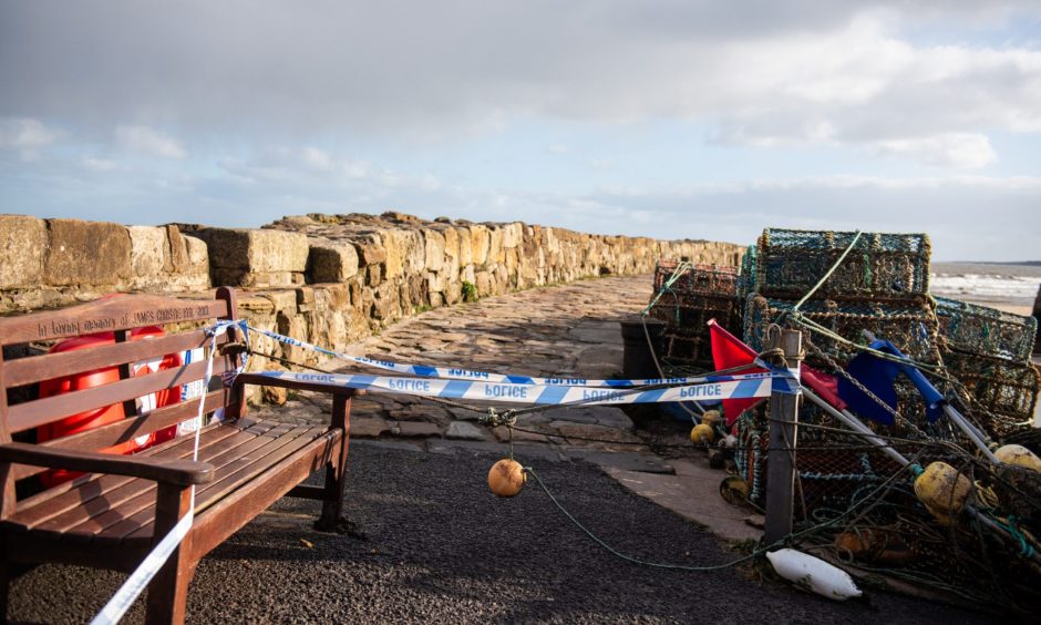 Police tape bars access to parts of St Andrews Harbour wall and pier