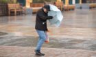 A man battles the winds in Dundee city centre on Thursday during Storm Babet.