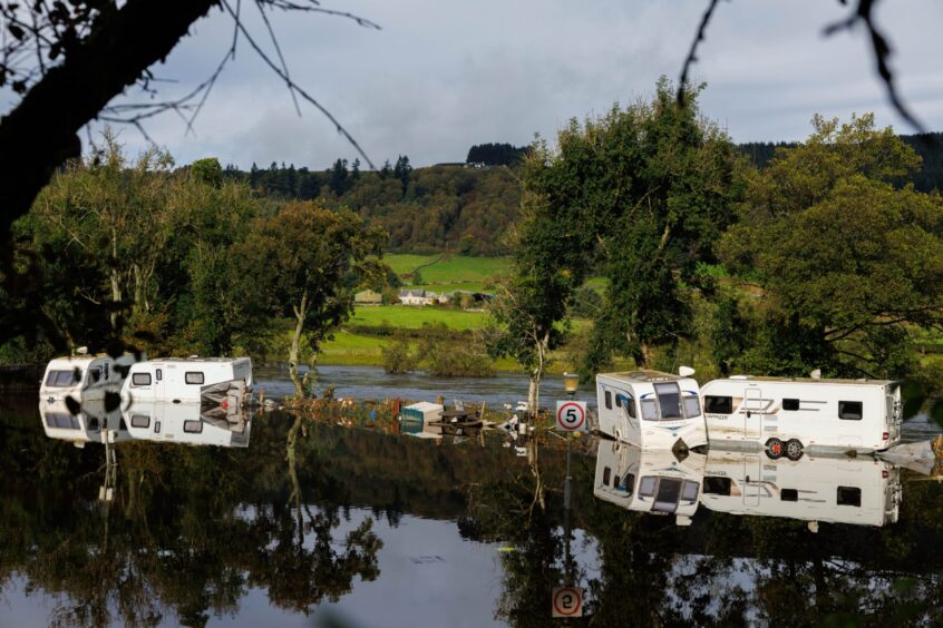 Four Caravans, parked haphazardly by the River Tay in Aberfeldy after Saturday's flooding.