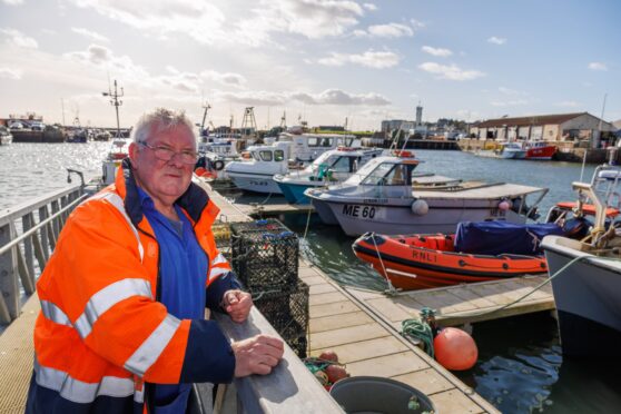 Alex Smith at the outer harbour pontoon with the Atlantic 85 and his boat a few berths away. Image: Kenny Smith/DC Thomson