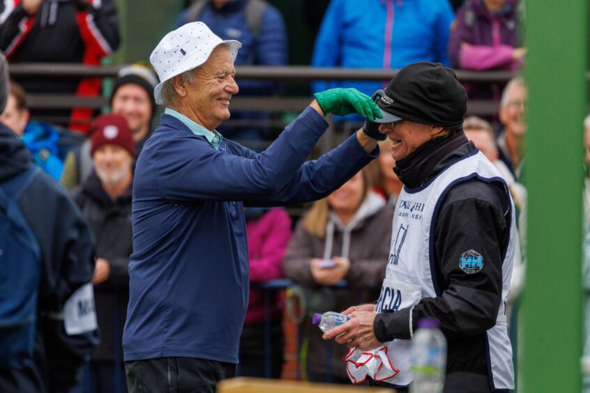 Dunhill Cup celebrities - Bill Murray fools around on the 1st tee with his caddie's cap